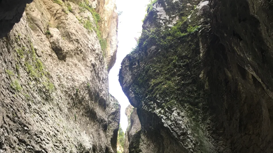 A cave-like opening in Holta Canyon with the river running below