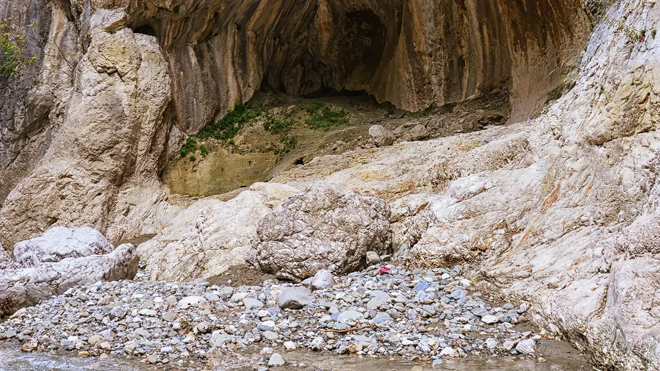 Water-carved rock chamber inside Holta Canyon with striated limestone walls