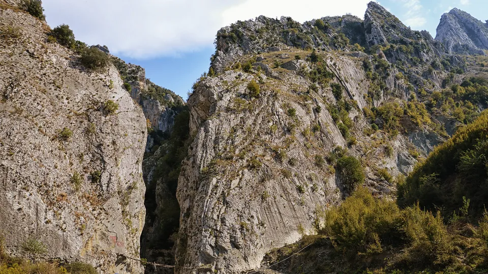 Holta Canyon's narrow gorge with a rope crossing over the riverbed